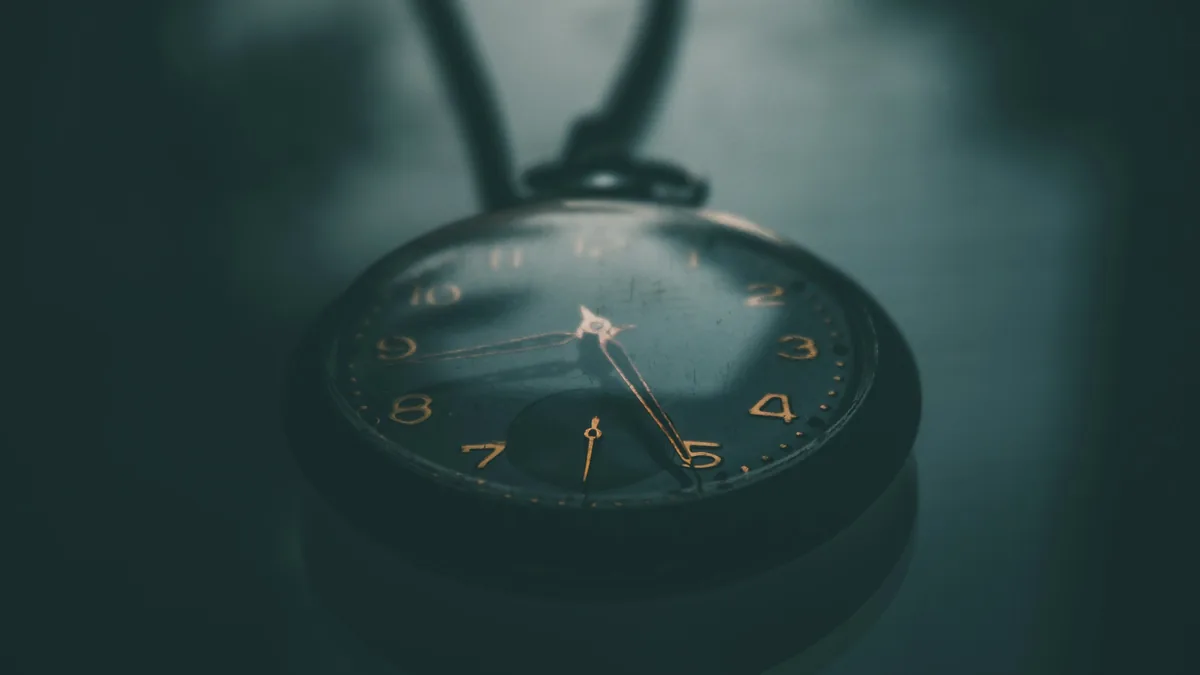 An antique pocket watch in dark light